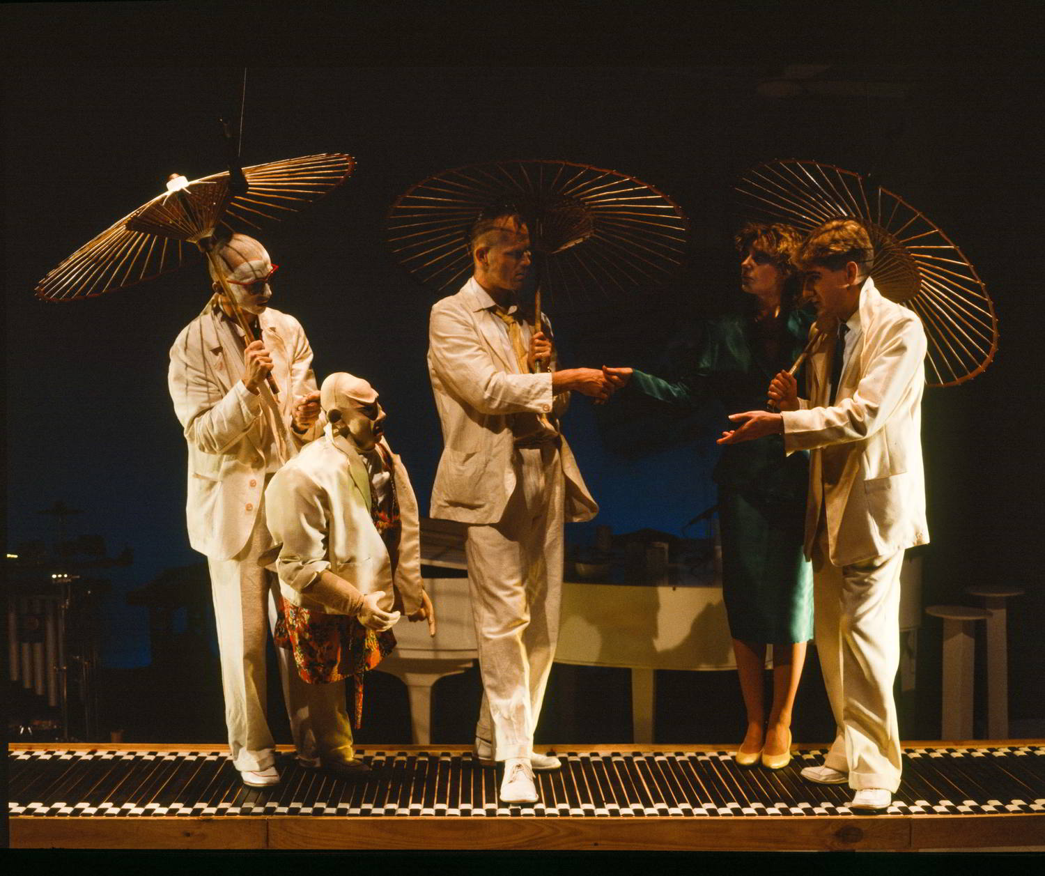 puppets and people under parasols on forestage