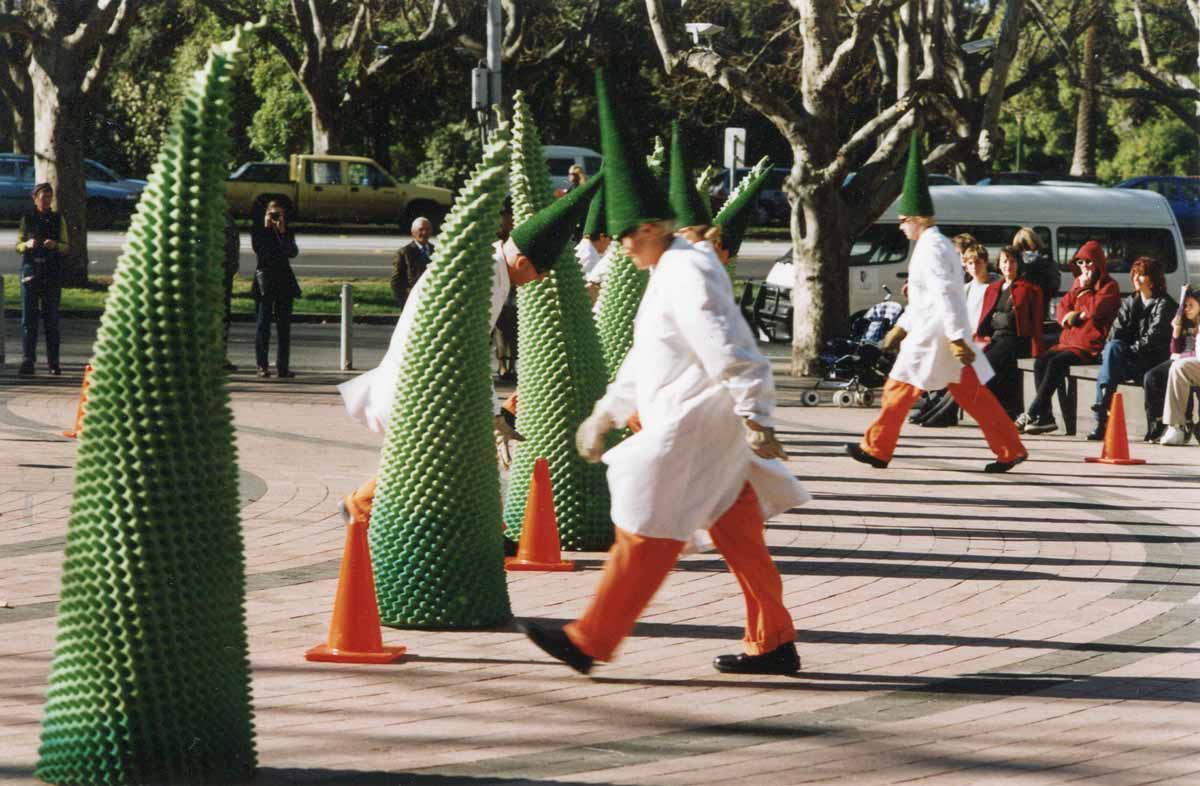 The Cone project Handspan Visual Theatre clowns in white lab coats with conical hats performing with green rubber cones