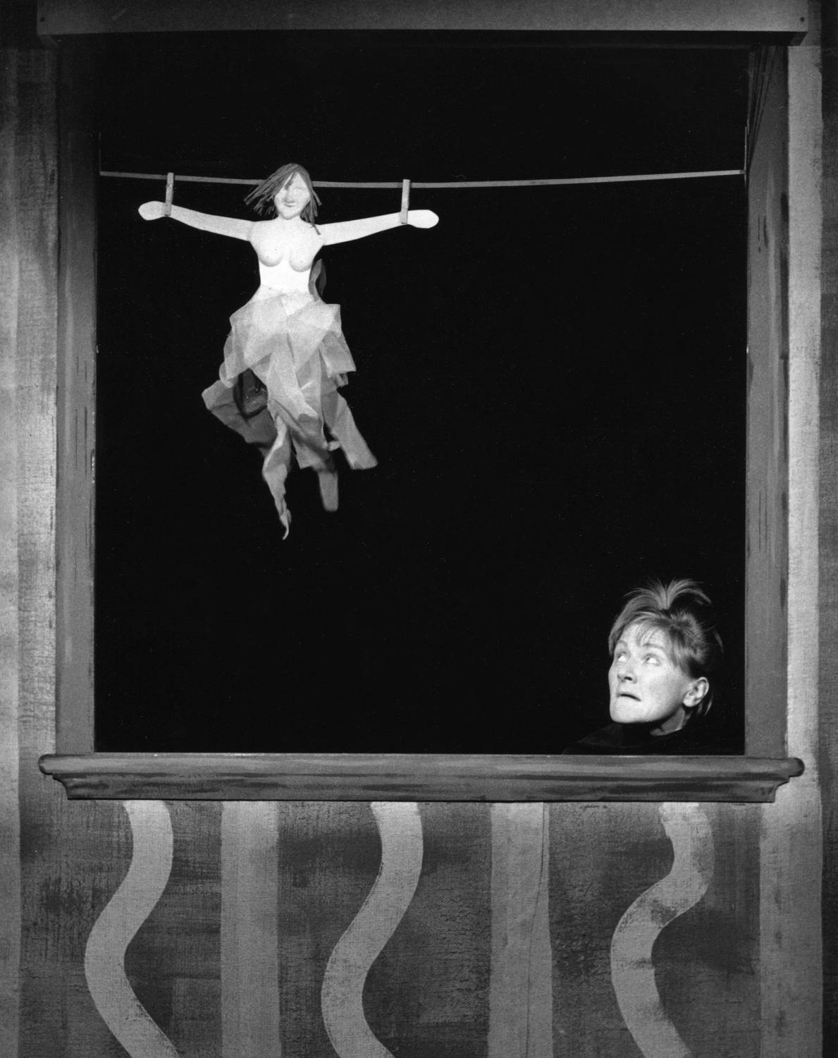 Handspan Theatre's Daze of Our Lives woman's face looking up front the bottom of a booth opening at a fairy figure hanging in the air