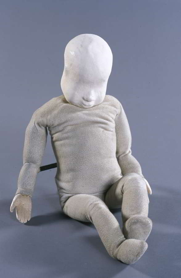 Handspan Theatre Baby Puppet white puppet with featureless face seated 