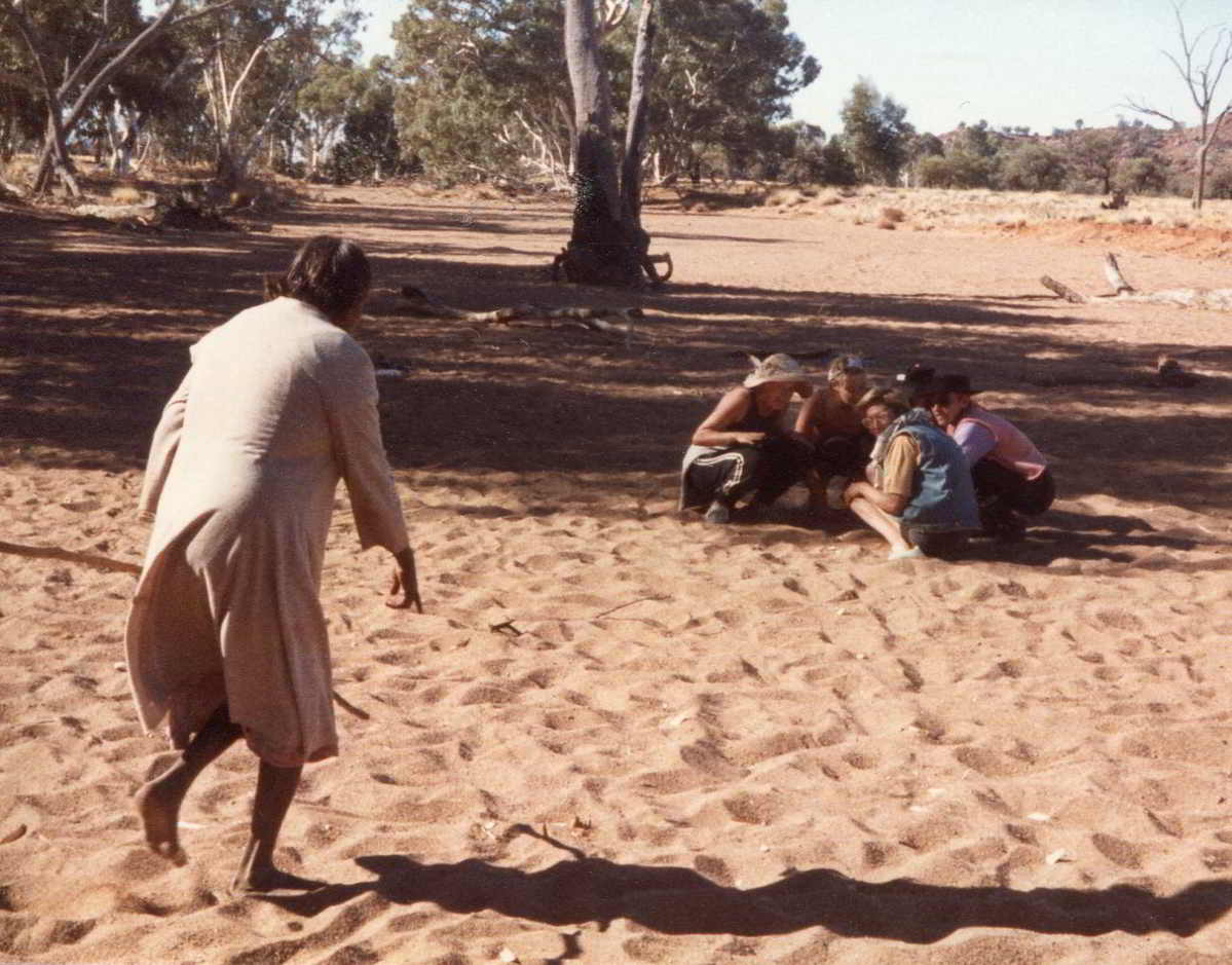 Handspan Theatre The Haunted indigenous woman running towards a group of crouching white fella women across sand