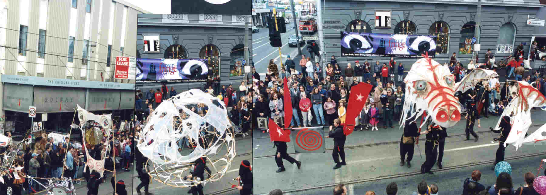 Held on the Breath of the Wind Handspan Theatre montage of 2 photos showing crowds on city street watching puppeteers pass holding aloft red banners, white dragon and ragged white paper sphere