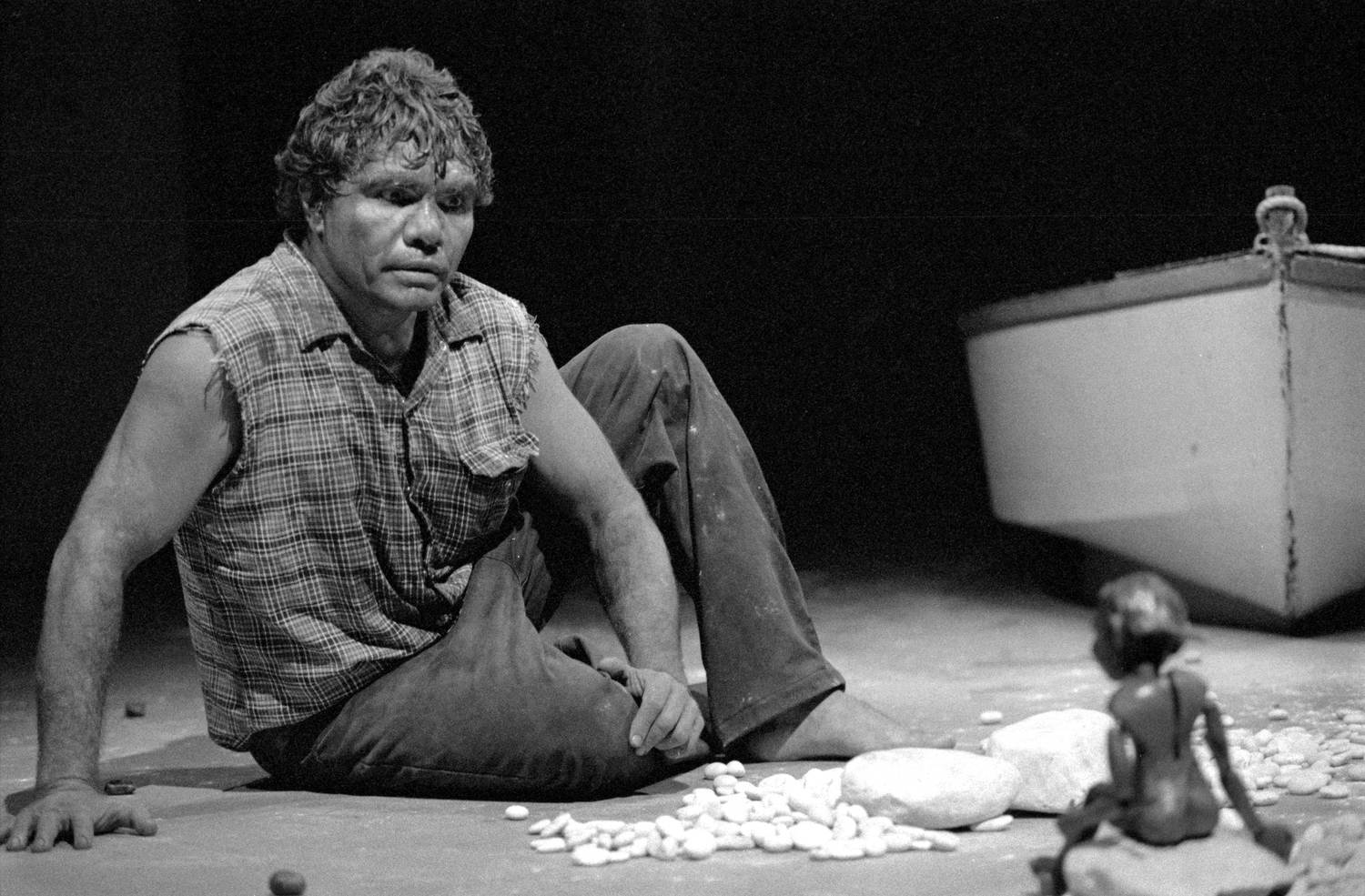 Lift Em Up Socks Handspan Theatre Aboriginal man sitting on floor conversing with puppet boy, black and white
