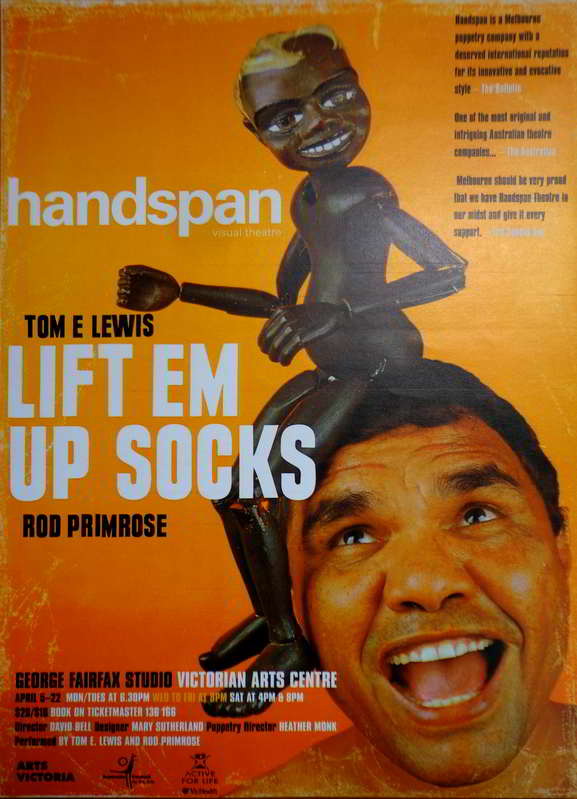 Handspan Theatre Lift 'Em Up Socks poster orange with Aboriginal puppet boy on man's head