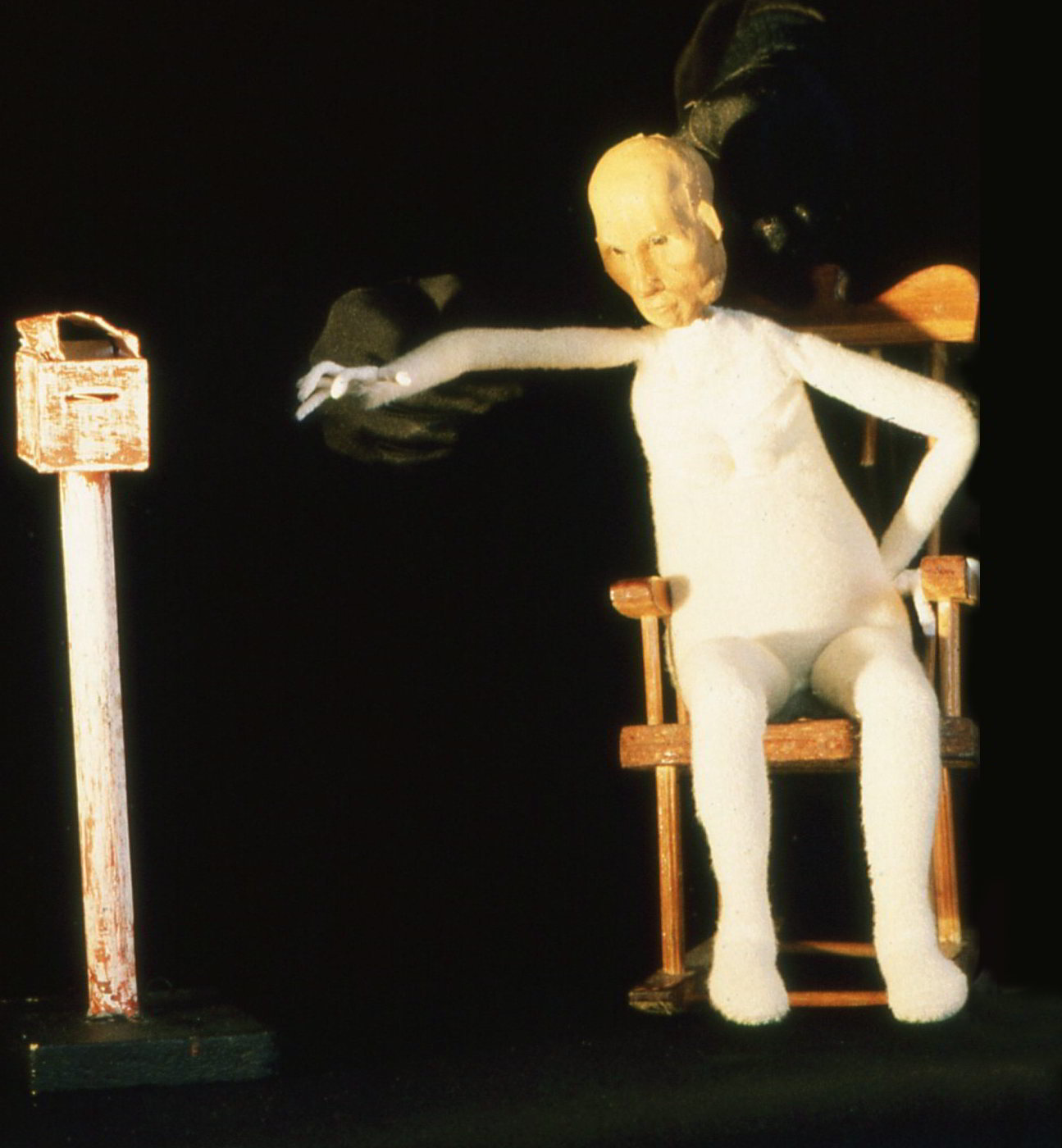 Handspan Theatre Moments Puppet figure of old woman stretching from rocking chair to letter box