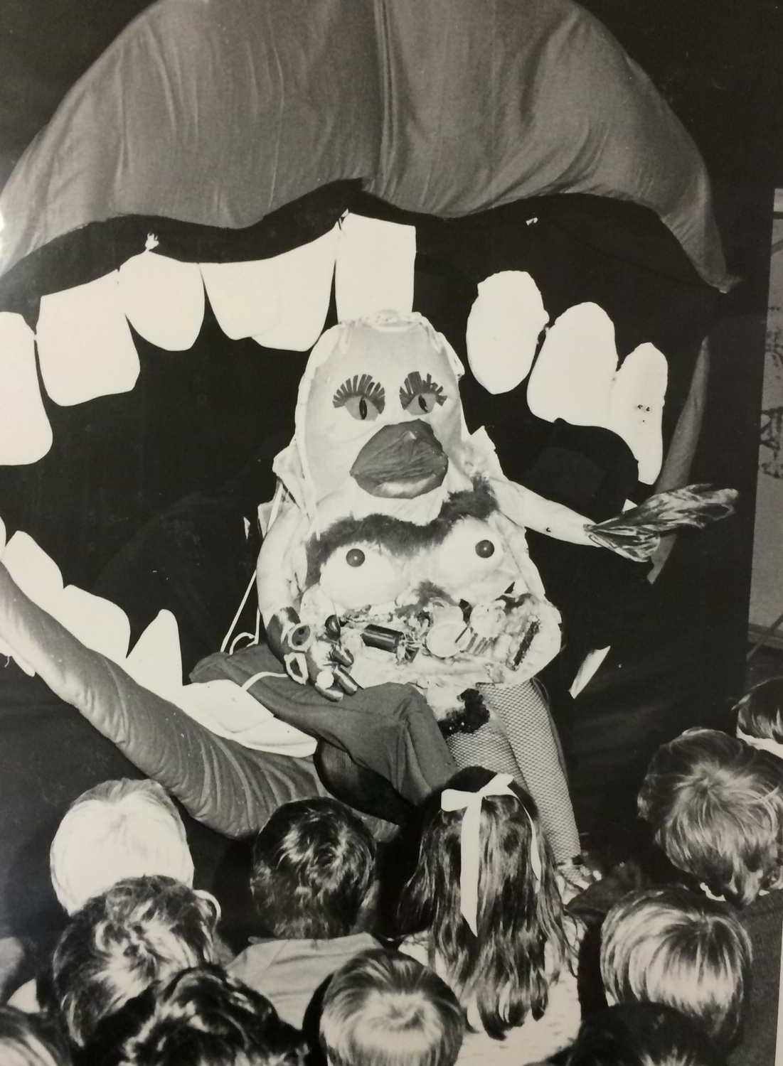 Handspan Theatre The Mouth Show, Sugar, a garish puppet with ice-cream breasts and cherry nipples being rolled into the mouth by its tongue