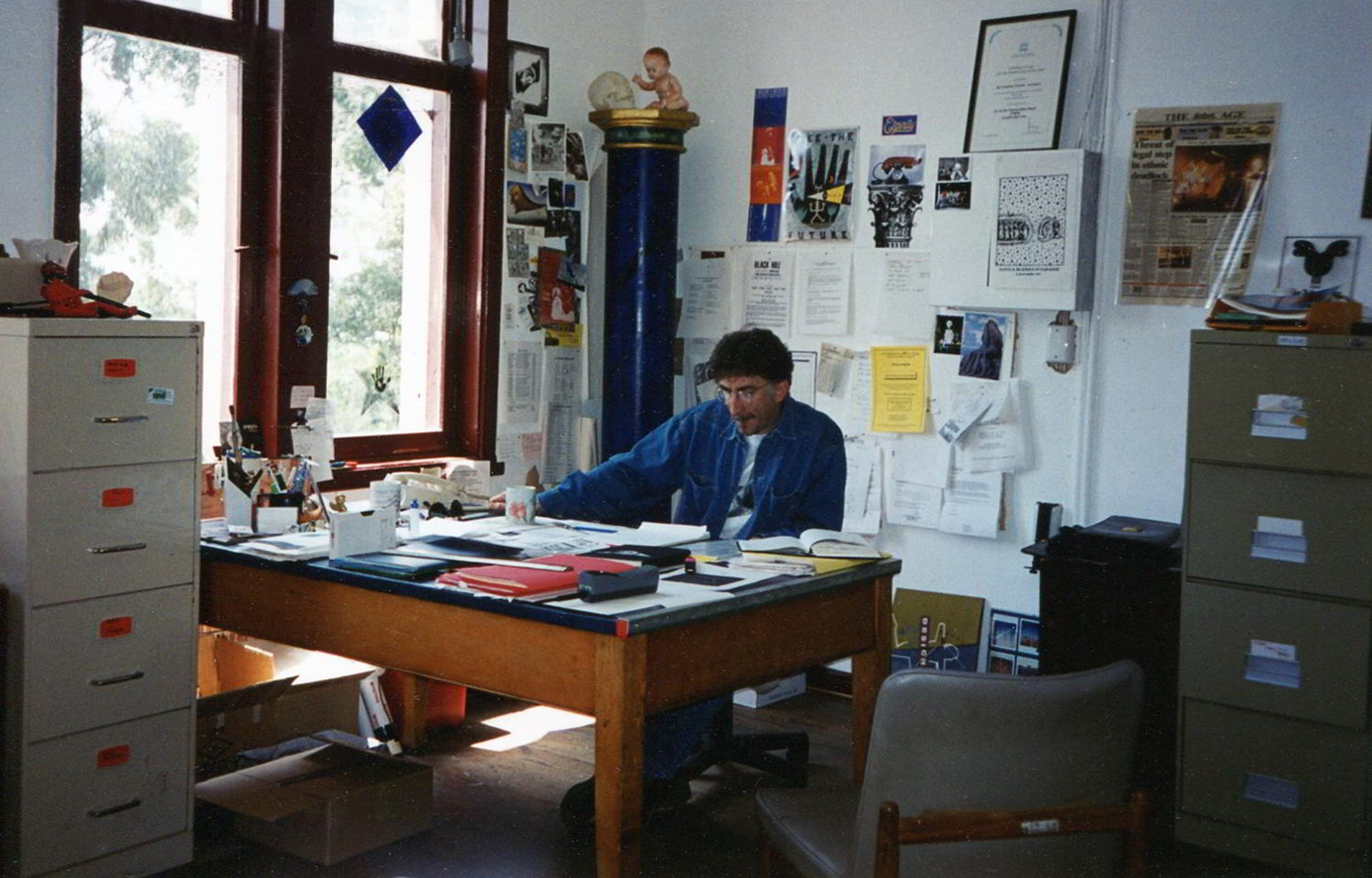 Ken Evans, Handspan Theatre, Artistic Director seated at a desk