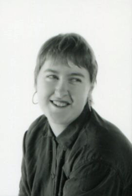 portrait of smiling woman with short hair looking slightly left