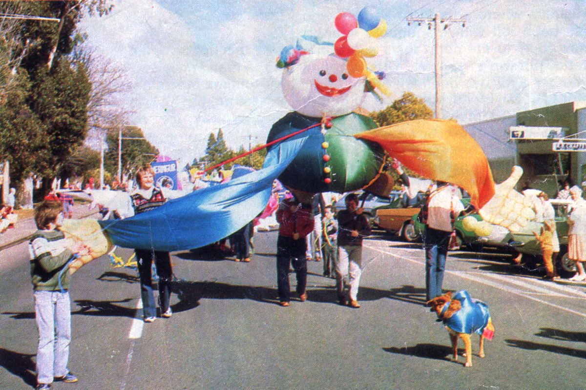 Street Parade led by helium balloon gnome puppet children and adults on a Mildura street, 