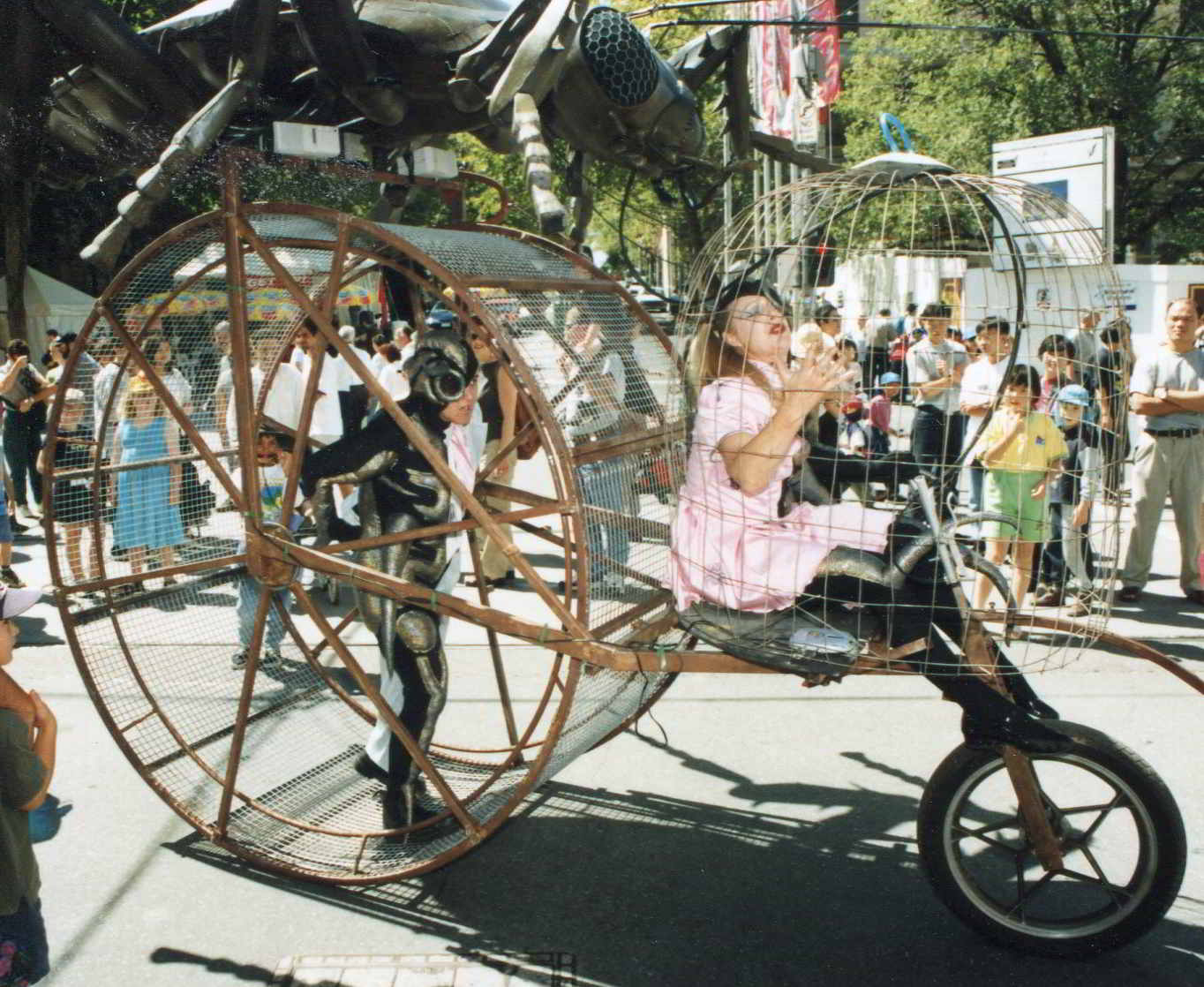 Road Roach side view of parade contraption showing wheel and first cage