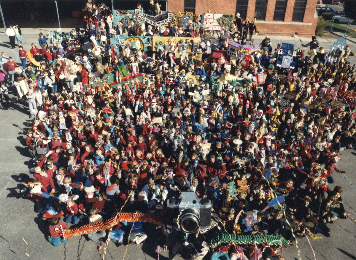 Handspan Theatre Snapshot artist-in-residency, Wangaratta - finale aerial view of massed crowd of children carrying puppets around a large camera