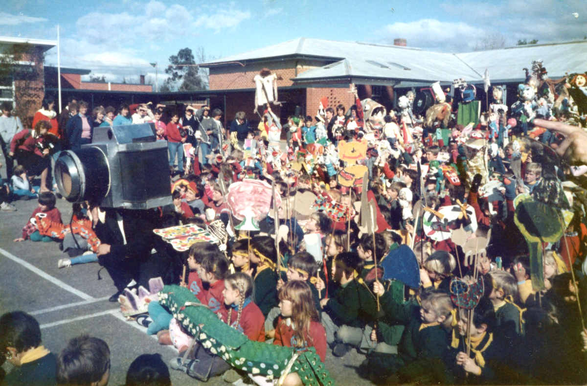Handspan Theatre Snapshot large prop camera in front of crowd of children holding puppets