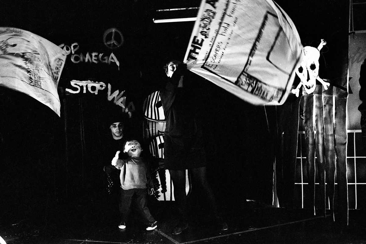 Streetwise Handspan Theatre boy puppet in spooky alleyway with  grafitti and flying newspaper