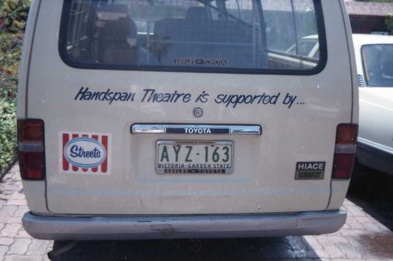 Handspan Theatre touring van - back of a white hiace van displaying streets logo