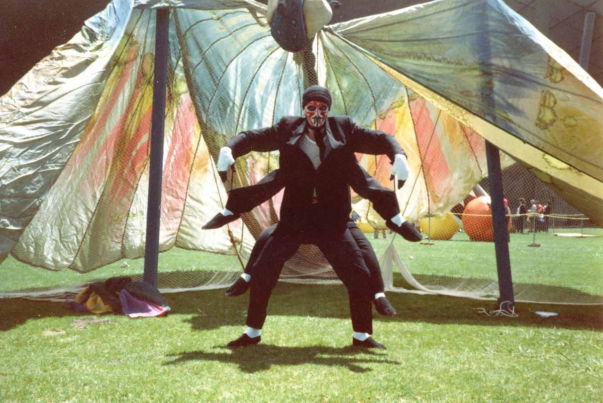 Handspan Theatre Sidney Spider's Muesli Bowl actor dressed in a spider costume in front of butterfly wing backdrop