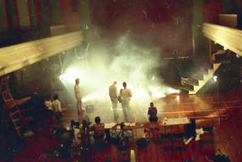 long view from hall balcony: people, props, sets and active smoke machine