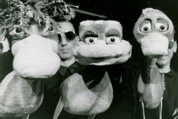 three puppeteers with three large duck puppets 