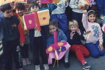 group of around 20 children with their puppet planes