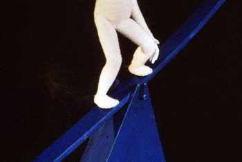 clothesline hung with items spelling the word Smalls behind man and woman with miniature clothesline