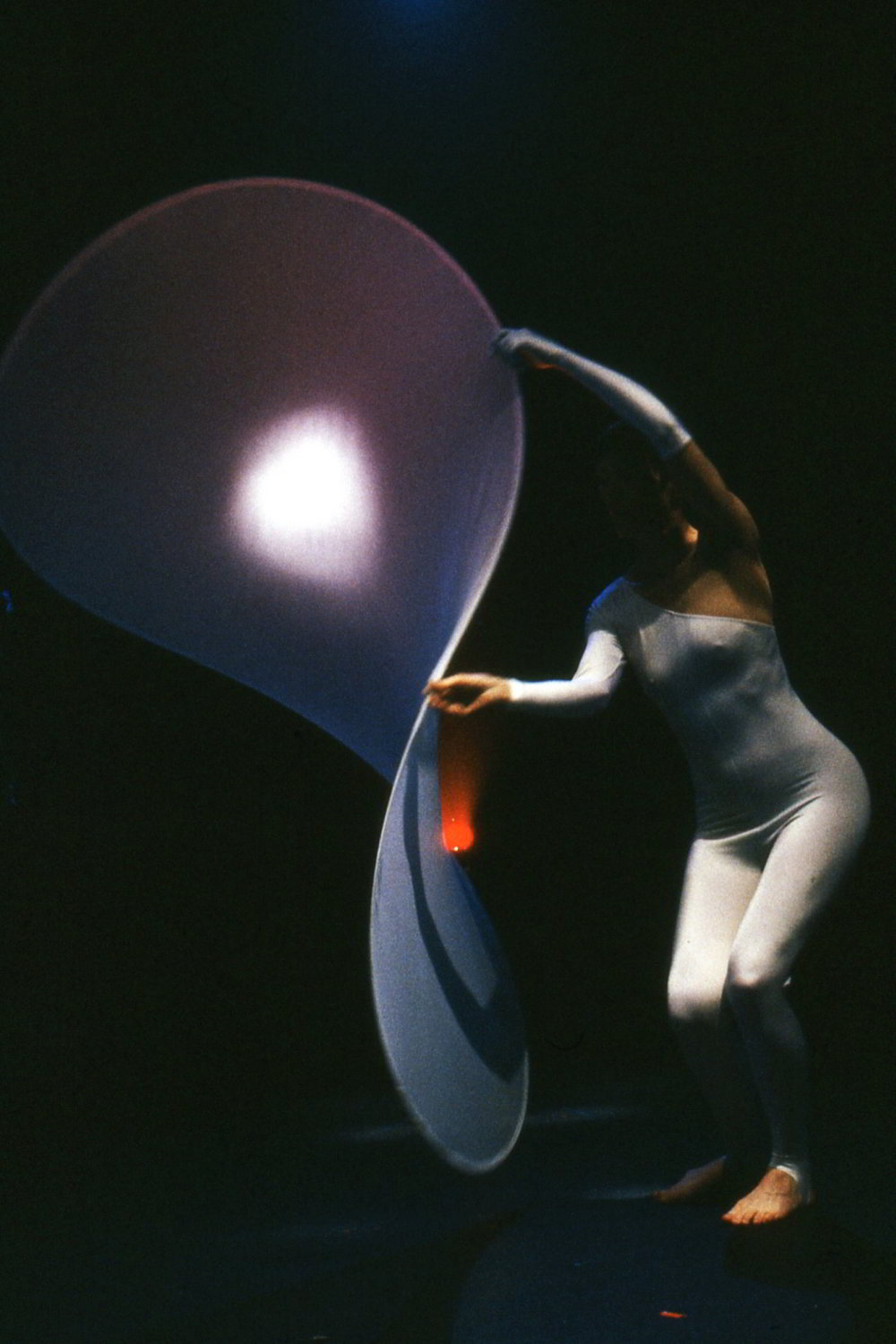 Metafour, Katy Bowman's Fluid Forms segment - a white clad figure swirling transparent figure eight object