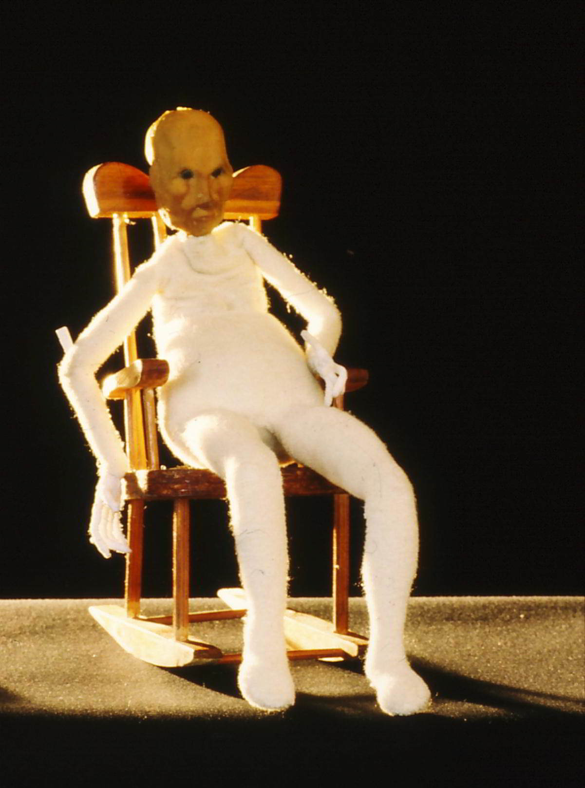 Handspan Theatre Moments Puppet figure of an old woman sitting alone in rocking chair