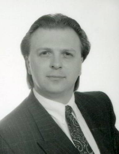 Handspan Theatre David Baird black and white portrait of man wearing a tie and facing the camera