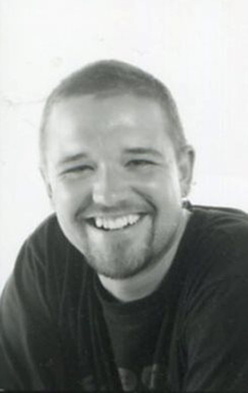 Mikkel Mynster Handspan Theatre portrait of a smiling faced man in black t-shirt