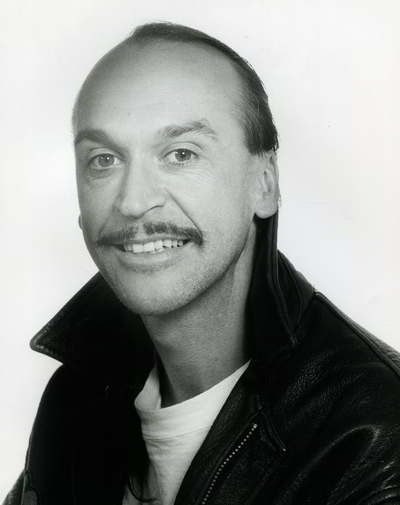 Handspan Theatre Peter J.Wilson black and white portrait of man with long hair wearing a leather jacket