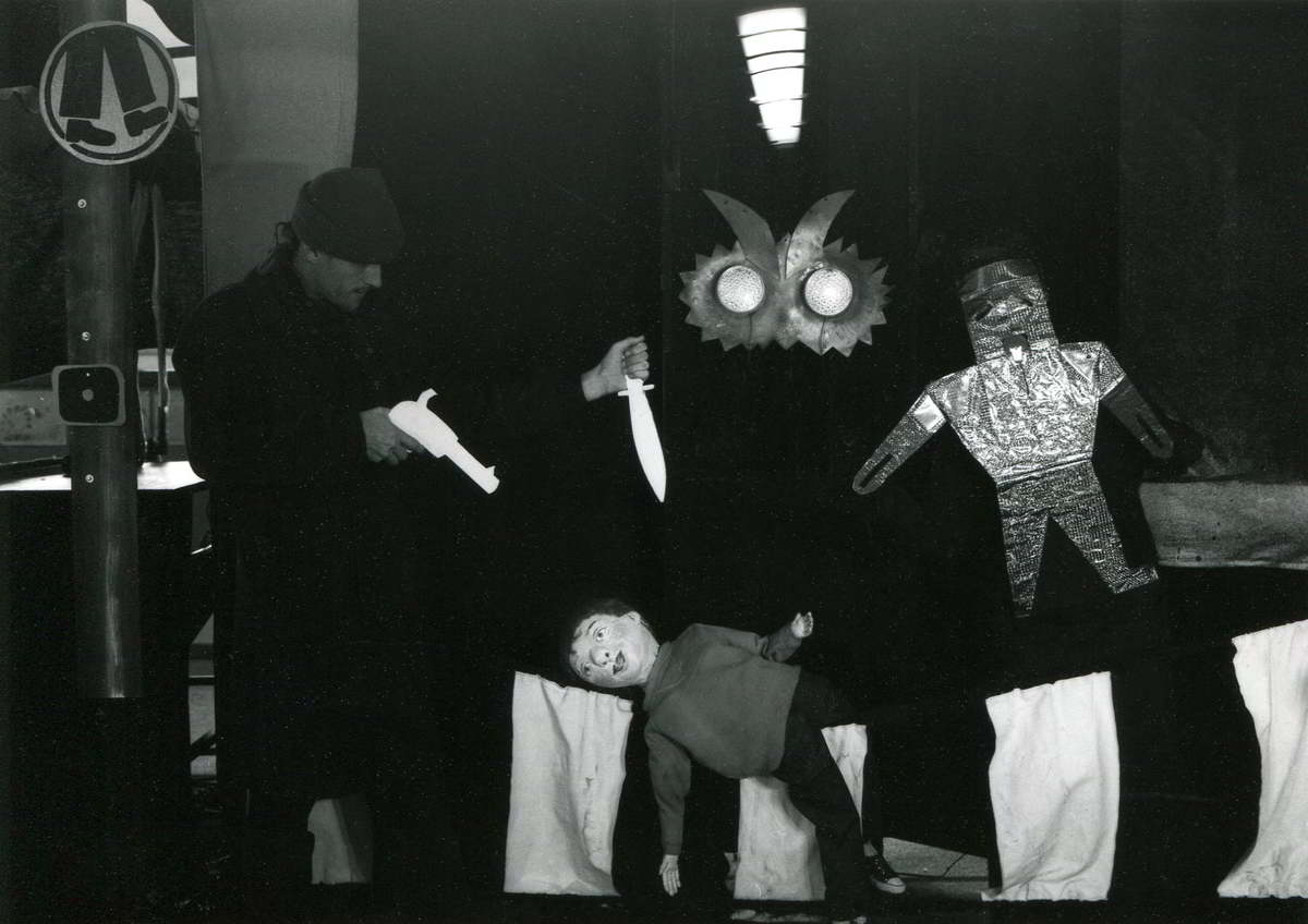Streetwise Handspan Theatre boy puppet lying on zebra crossing imagining daggers and monster eyes