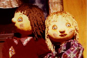 close-up of two puppets, a girl and a boy
