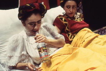 in bed two Fridas share a drink