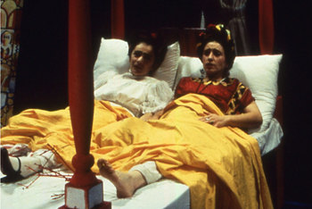 two fridas conversing side by side in four-poster bed